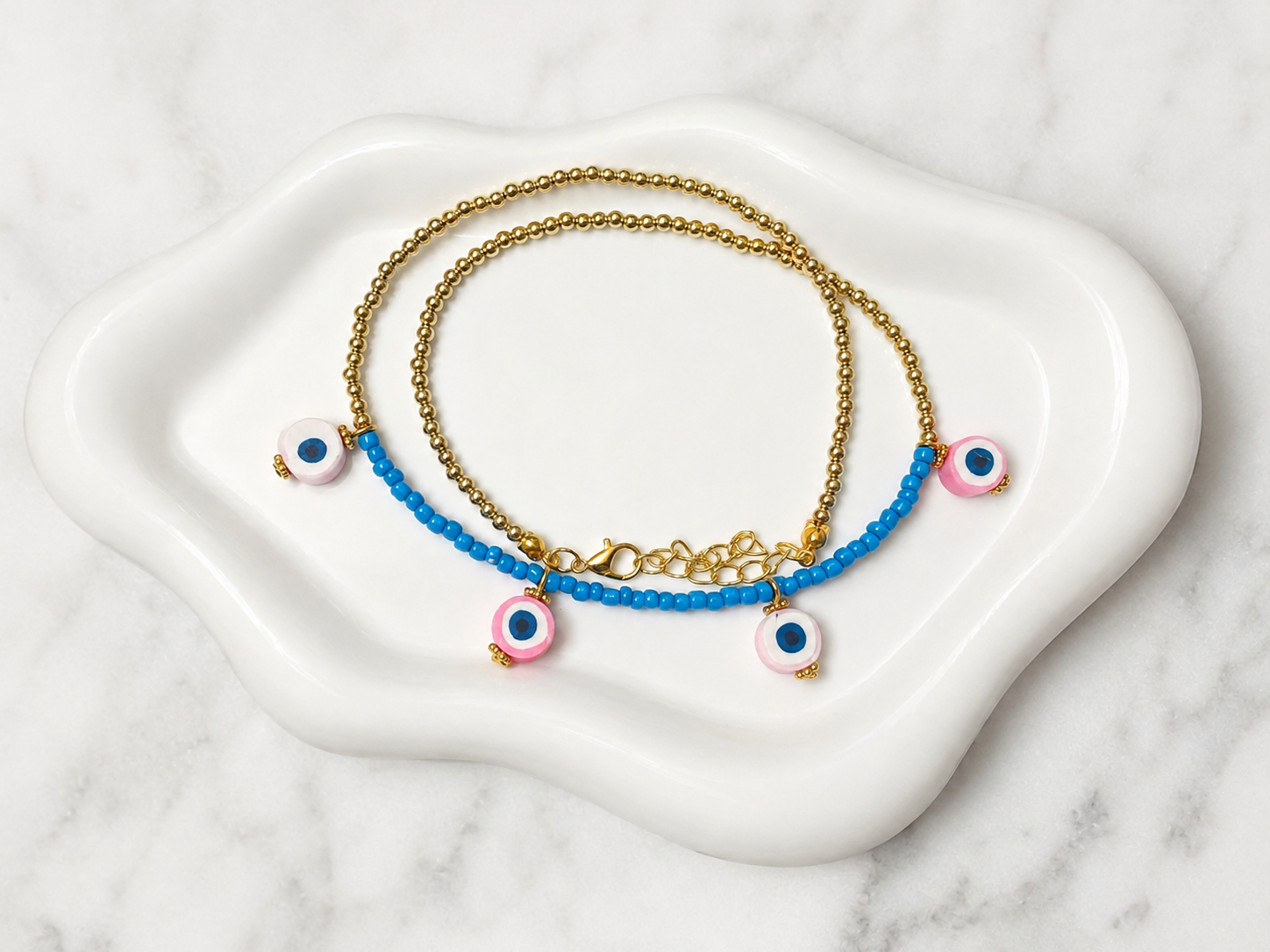 Colorful handmade bracelets worn beside bright flowers