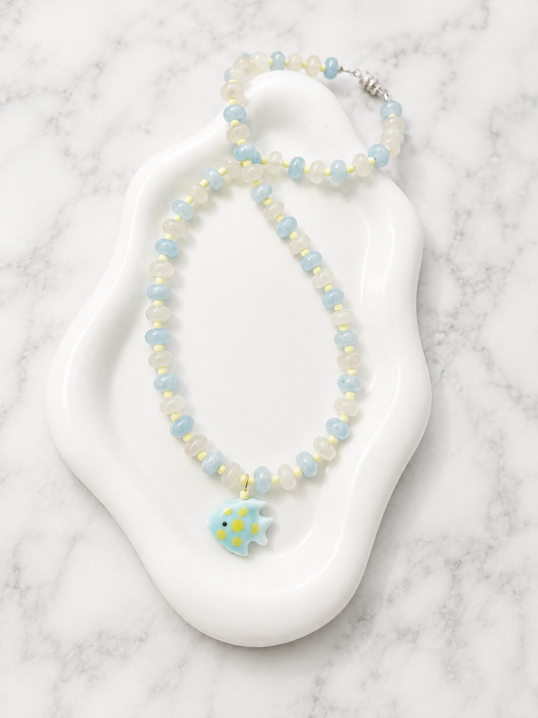 Delicate handmade bracelet displayed on a white surface